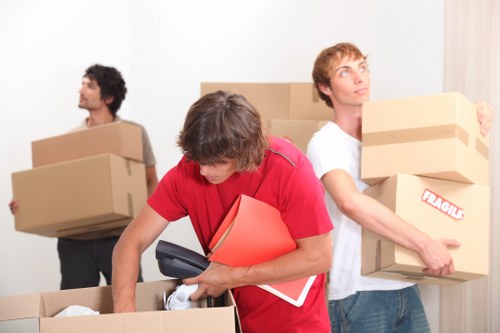 Local office moving team handling desks and equipment during an Enfield business relocation