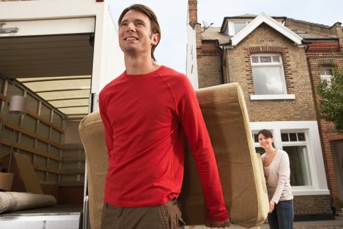 Packed moving boxes and furniture ready for a removal van in Enfield