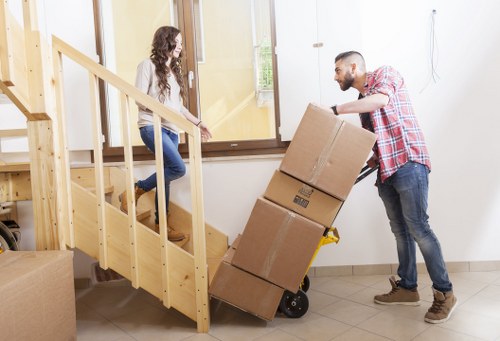 Local removals crew handling furniture in an Enfield property